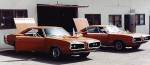 This is at a warehouse on Cumpston St. in North Hollywood where my father had a storage spot; there's now an apartment building there. The photo shows me taking the best parts off of a second real Super Bee (it was green before we fogged it orange) and moving them onto my own car before the Double Bee was sold.  &raquo; Click to zoom ->