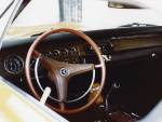 The Bee's interior was factory burnt orange, as the steering wheel shows, with buckets and a console. Most of it had been dyed black by the time I got the car. Some girl gave me the stuffed Garfield and it took a couple months for me to figure out it was not cool to leave in the car.  &raquo; Click to zoom ->