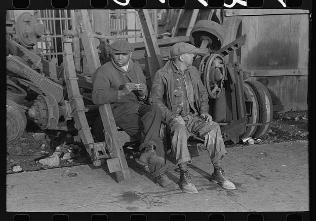 Men at junkyard on coffee break