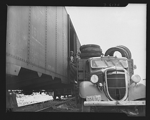 Tires being loaded onto junkyard truck