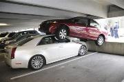 WEIRD WRECK VIDEO: A HONDA MOUNTS A CADDY INSIDE A PARKING GARAGE!