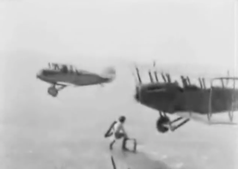 AMAZING HISTORICAL VIDEO: A WING WALKER FROM THE TWENTIES CHANGES THE WHEEL ON A PLANE IN MID-FLIGHT