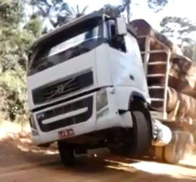 Torque Brutality Video: Watch A Big Rig Hauling Trailers Of Logs Lug Up A Hill And Nearly Twist Itself Into a Pretzel