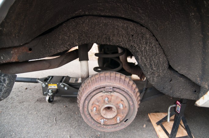 Knowing that it would be the easier job, I quickly ripped into the rear suspension. The drums and shoes had plenty of life in them, but looked original. Check out all of that undercoating; it's about a half inch thick in spots and covers the entire frame. While it kept the car from rotting away, I would come to hate its existence shortly.