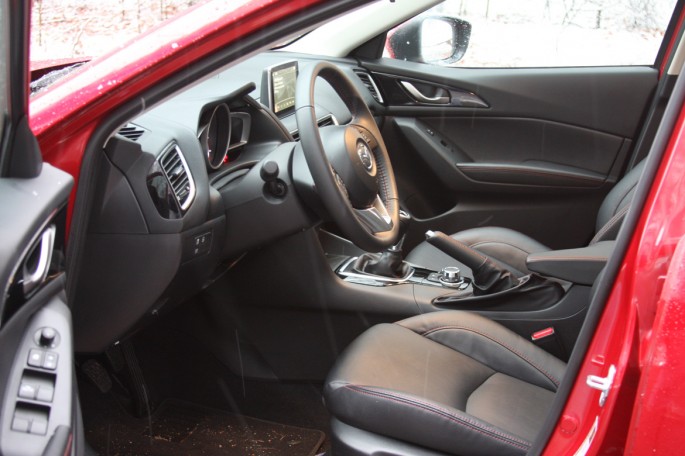 Because this car had the "Grand Touring" package the interior was upgraded to leatherette all round. The red stitching on the seats, wheel, and other surfaces looked cool and the interior of the car was definitely a racy feeling place to be. One complaint that I have with this interior and many others is the fact that virtually everything is black. This is nightmarish when the car ages some and you are constantly having to clean it, etc. It was handsome though and I may just have a mental problem. You mileage could vary. The driver and passenger buckets were great. lots of support, super comfy. The steering wheel is meaty and there are nice grips on it. Cruise, audio, etc have redundant controls on the wheel. I wasn't really into the faux carbon fiber accents that could be found in the cabin. 