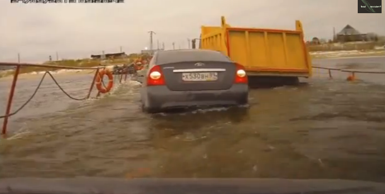 Watch A Huge Dump Truck Nearly Scuttle A Floating Bridge In Siberia – Cars Almost Float Down River!