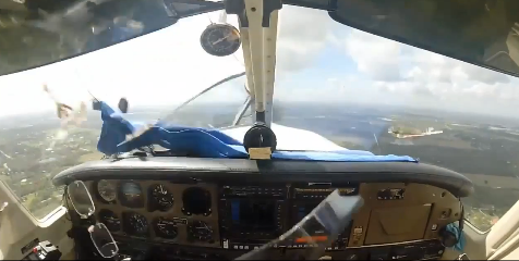 Watch A Bird Strike Knock The Front Window Out Of A Small Plane On Landing Approach – Pilot Handles It Like Boss