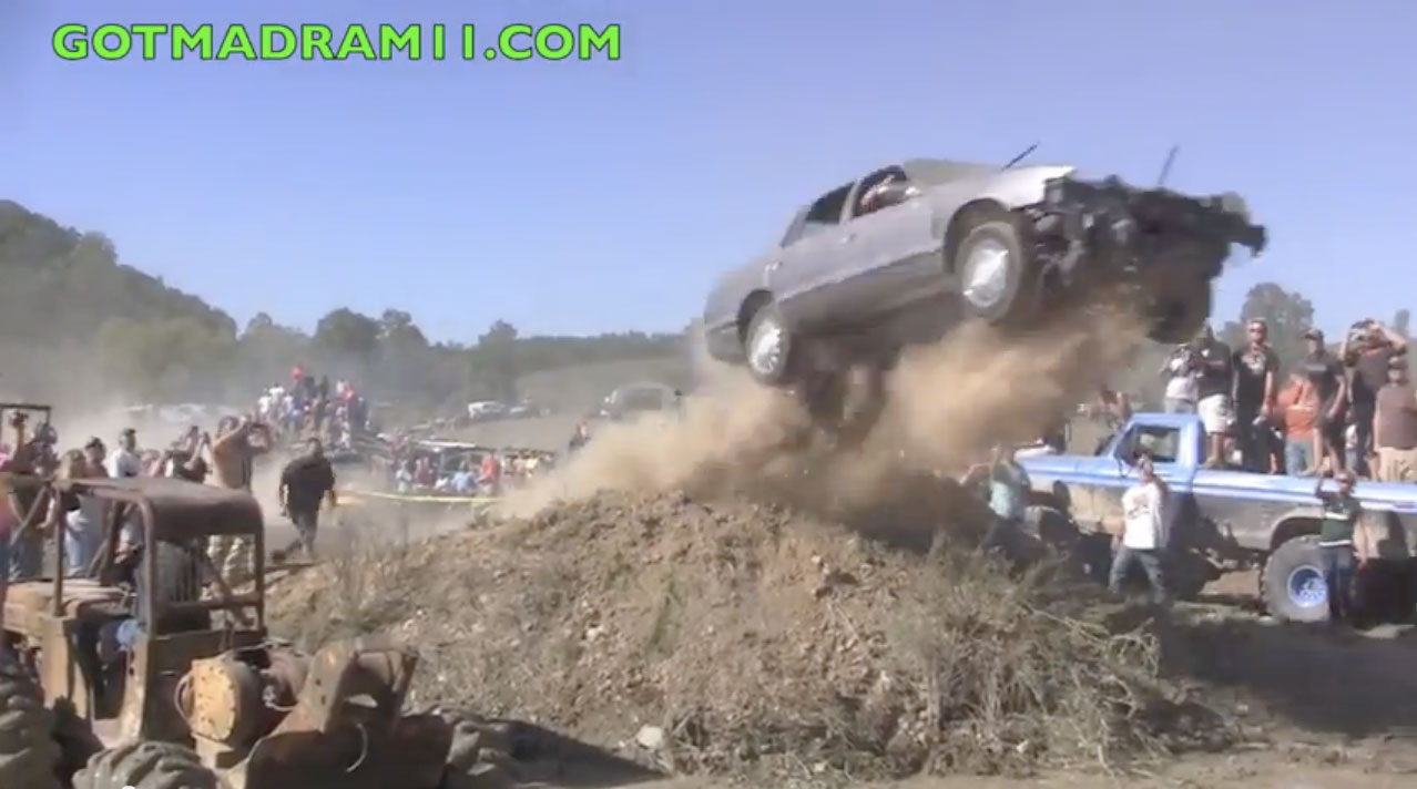 Video:Watch Two Lunatics Jump A Cadillac Into A Mud Bog Pit and Nearly Drown – Southern Fried Fun