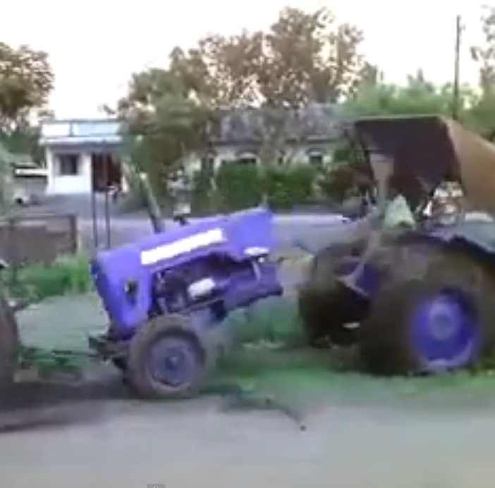 Watch A Farmer Accidentally Rip A Friend’s Tractor In Half While Trying To Pull Him Out Of The Mud!