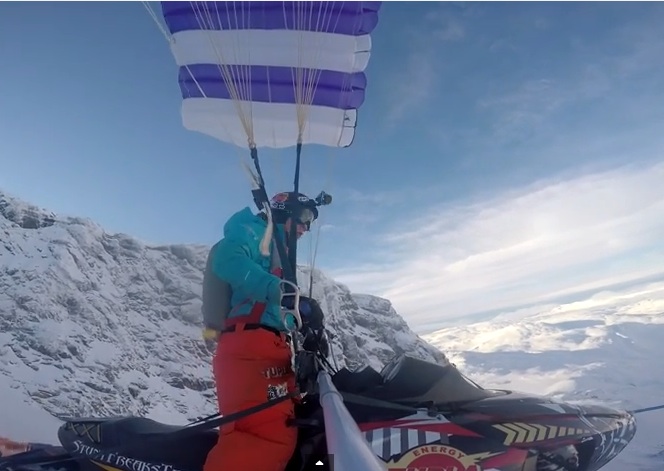 Watch This Insane Video Of A Dude Driving His Snowmobile Off A Cliff And Using A Parachute To Save His Bacon