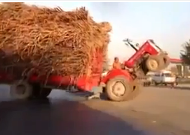 Not A Stunt, Not A Joke, This Guy Is Driving The Tractor Like This Down The Road On Purpose!