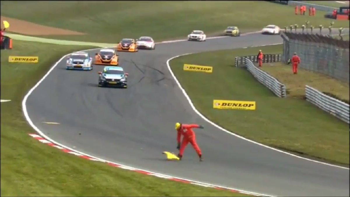 Watch a marshal nearly turn himself into a Toyota hood ornament at a touring car race