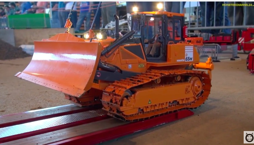 Check Out This Big Remote Control Bulldozer And Watch It Ride Around On The Back Of A Cool Remote Control Big Rig!