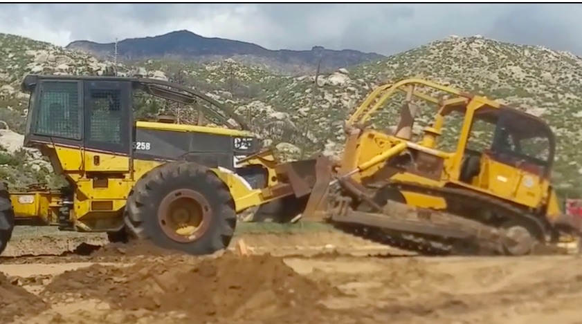 Battle! Watch A Log Skidder and A Bulldozer Have A Push-Off In The Wild!