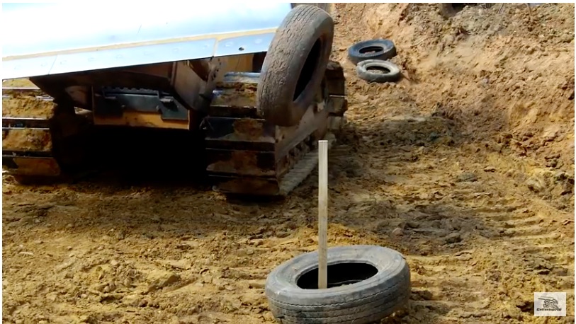 Got Skills? Watch This Bulldozer Operator Stack Tires Around A Stake Using The Blade Of His Machine